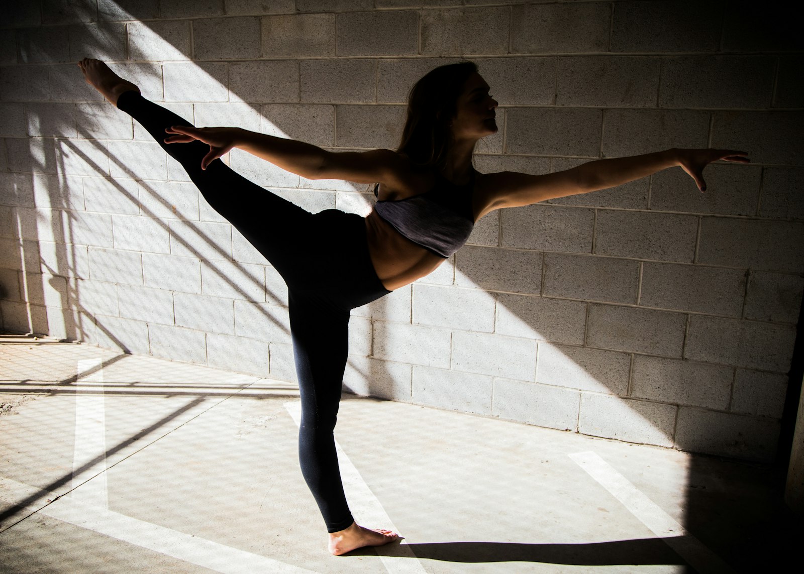 A woman standing tall in a white studio