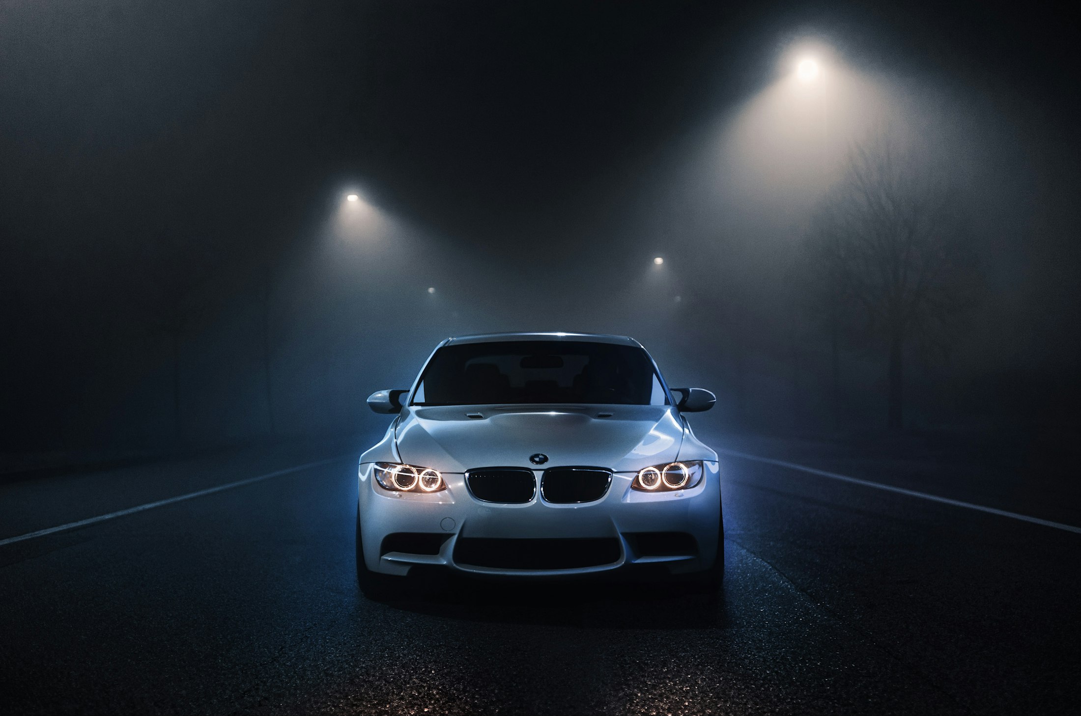A car with its headlights on in the dark